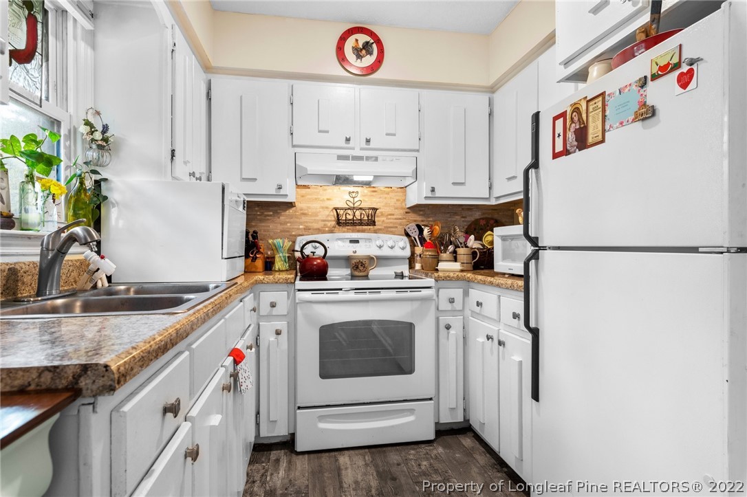 15921 Palmer Road Marston, NC 28363 - Photo 36 of 39 a kitchen with stainless steel appliances granite countertop a sink and a refrigerator