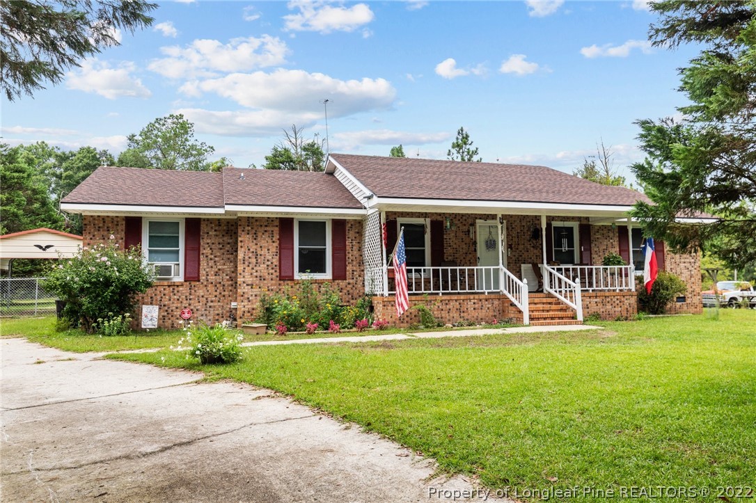15921 Palmer Road Marston, NC 28363 - Photo 4 of 39 a front view of a house with a yard table and chairs
