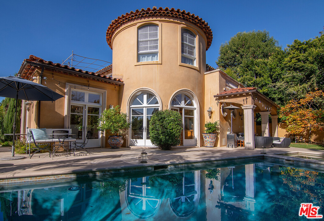 a front view of house with a garden