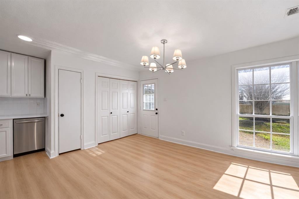 5516 Maple Lane Rowlett, TX 75089 - Photo 7 of 18 a view of a big room with windows and chandelier
