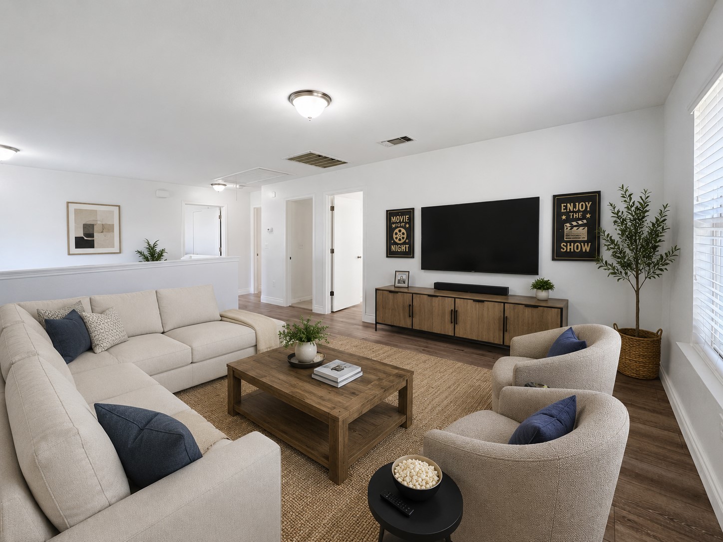 251 Triumph Road Buda, TX 78610 - Photo 18 of 31 Hardwood-style flooring and overhead lighting create a luminous and inviting gathering space.