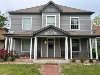 a front view of a house with a garden and plants