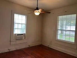 a view of a room with wooden floor and windows