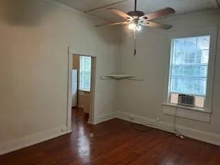 wooden floor in an empty room with a window