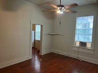 617 West Gandy Street, Unit 2 Denison, TX 75020 - Photo 7 of 15 wooden floor in an empty room with a window