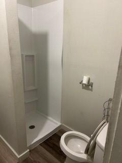 617 West Gandy Street, Unit 2 Denison, TX 75020 - Photo 10 of 15 a bathroom with a granite countertop toilet and a shower