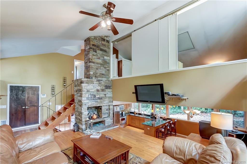5314 Valley Forge Road Charlotte, NC 28210 - Photo 12 of 48 a living room with furniture a fireplace and a flat screen tv