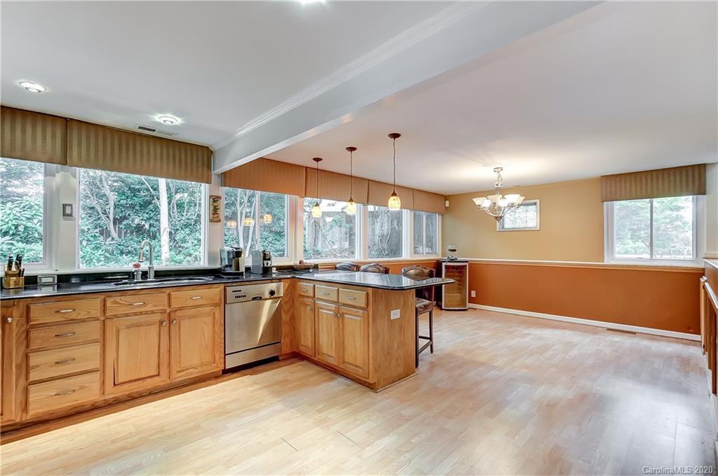 5314 Valley Forge Road Charlotte, NC 28210 - Photo 17 of 48 a large kitchen with kitchen island a large window a sink and stainless steel appliances