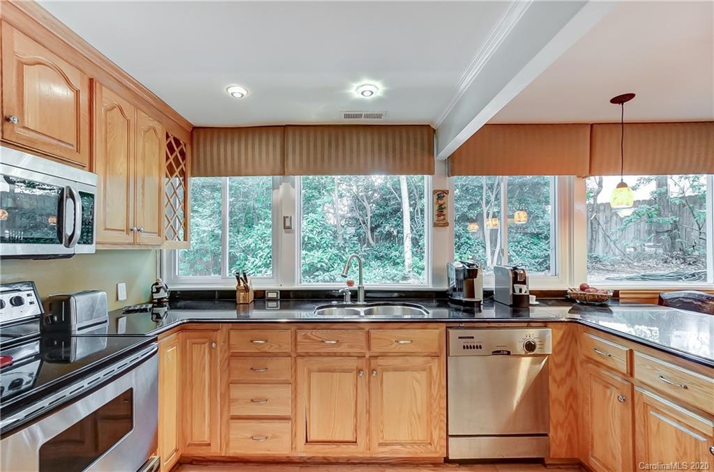 5314 Valley Forge Road Charlotte, NC 28210 - Photo 24 of 48 a kitchen with stainless steel appliances granite countertop a sink a stove and a microwave