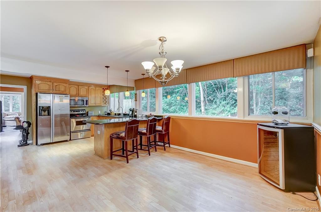 5314 Valley Forge Road Charlotte, NC 28210 - Photo 28 of 48 a view of a dining room with furniture a chandelier and wooden floor