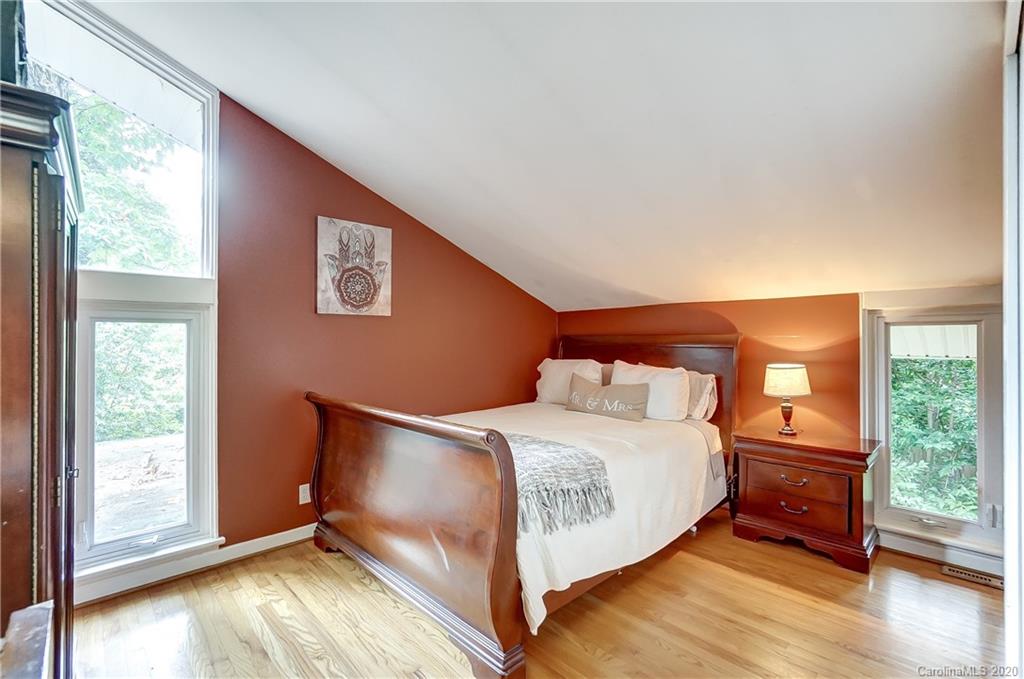 5314 Valley Forge Road Charlotte, NC 28210 - Photo 40 of 48 a bedroom with a bed and wooden floor