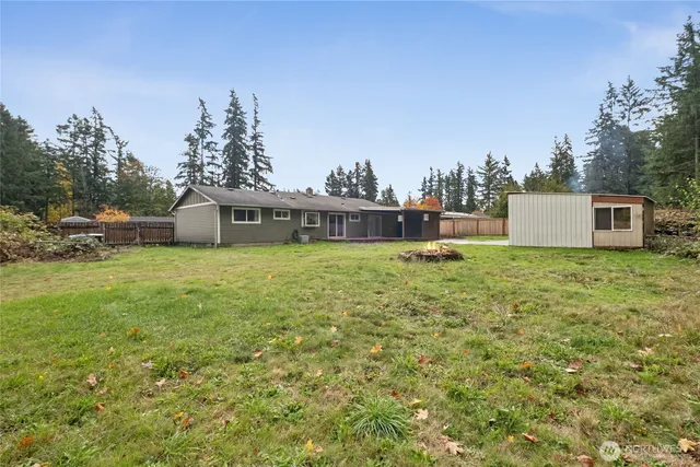 a view of a house with a yard and sitting area