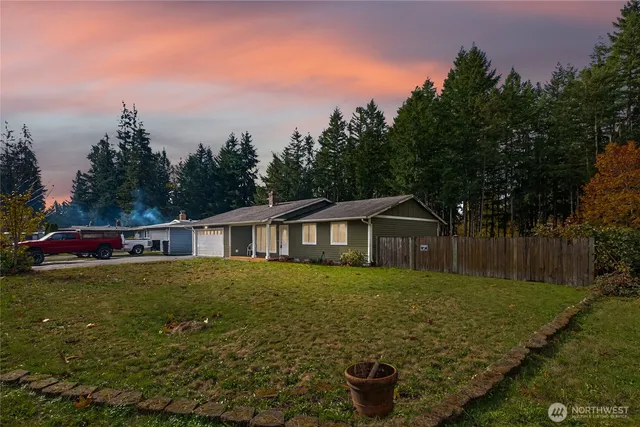 a view of a house with a yard and potted plants