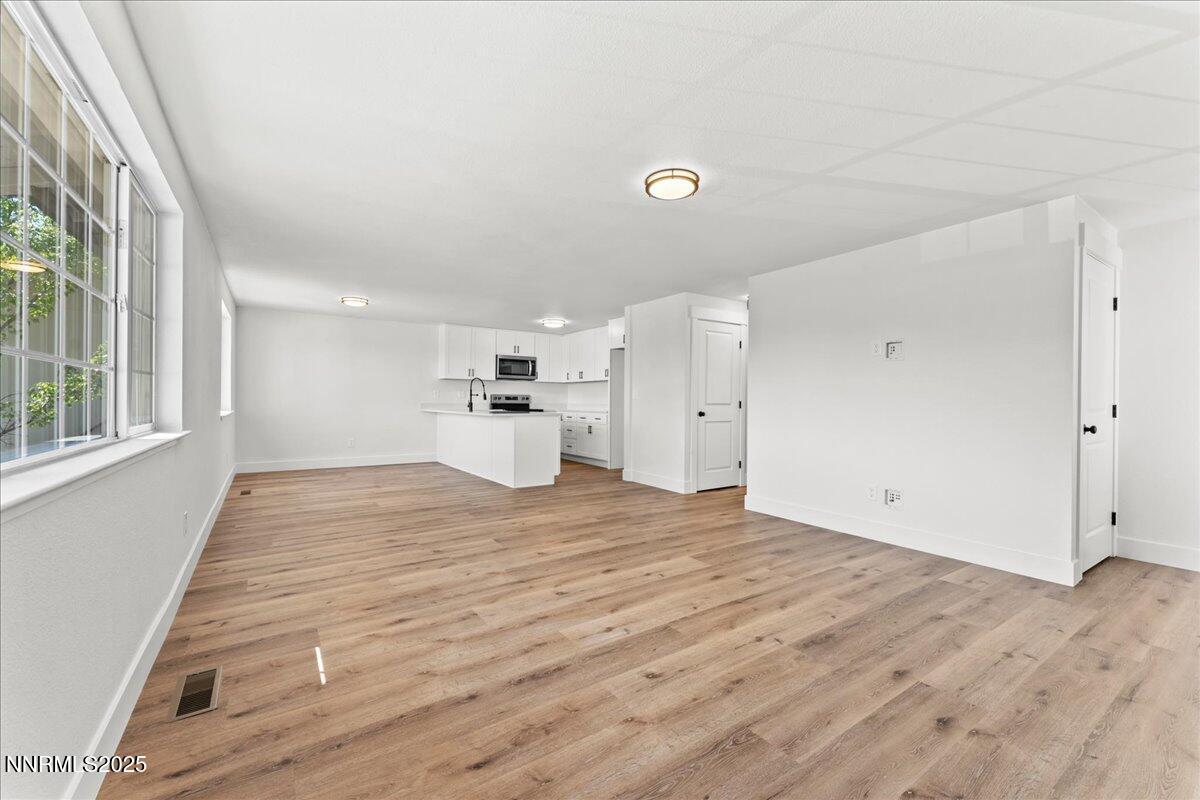 1075 Hartford Court Reno, NV 89503 - Photo 4 of 24 a view of empty room with wooden floor and window