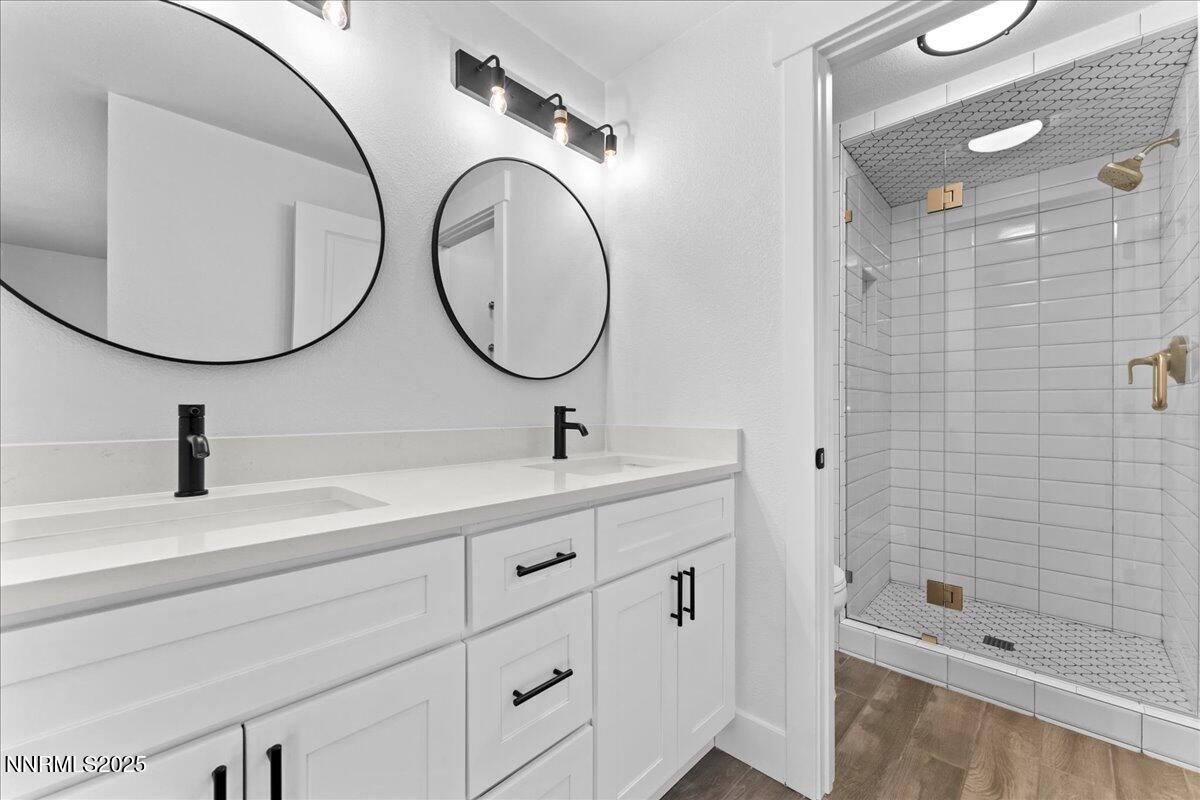 1075 Hartford Court Reno, NV 89503 - Photo 8 of 24 a bathroom with a double vanity sink mirror and shower