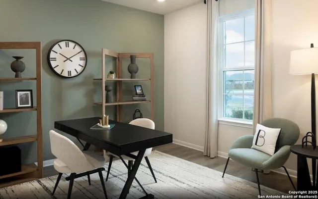 a view of a dining room with furniture and a large window