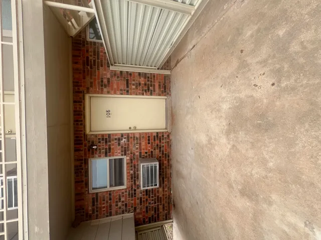 a kitchen with a sink a stove and white cabinets