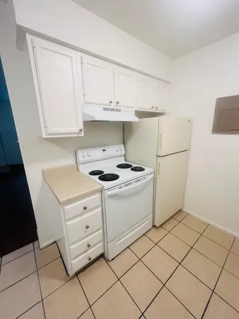 a kitchen with a cabinets and a stove top oven