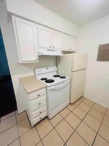 a kitchen with a cabinets and a stove top oven