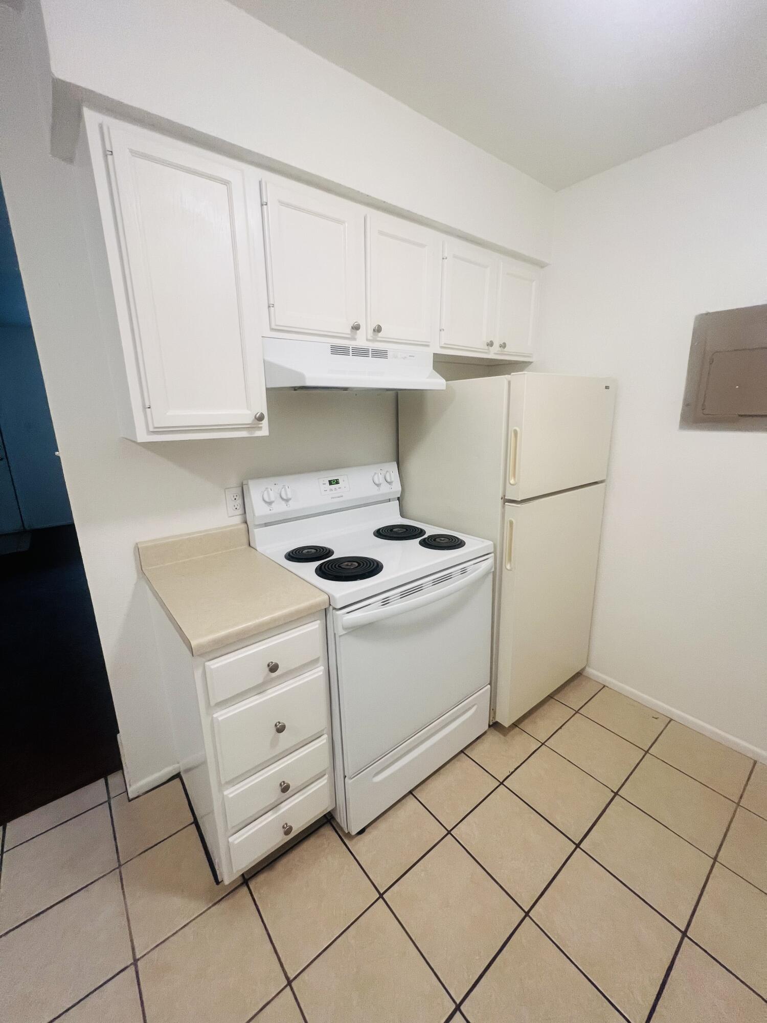 802 Matthew Avenue Sundown, TX 79372 - Photo 15 of 22 a kitchen with white cabinets and white appliances