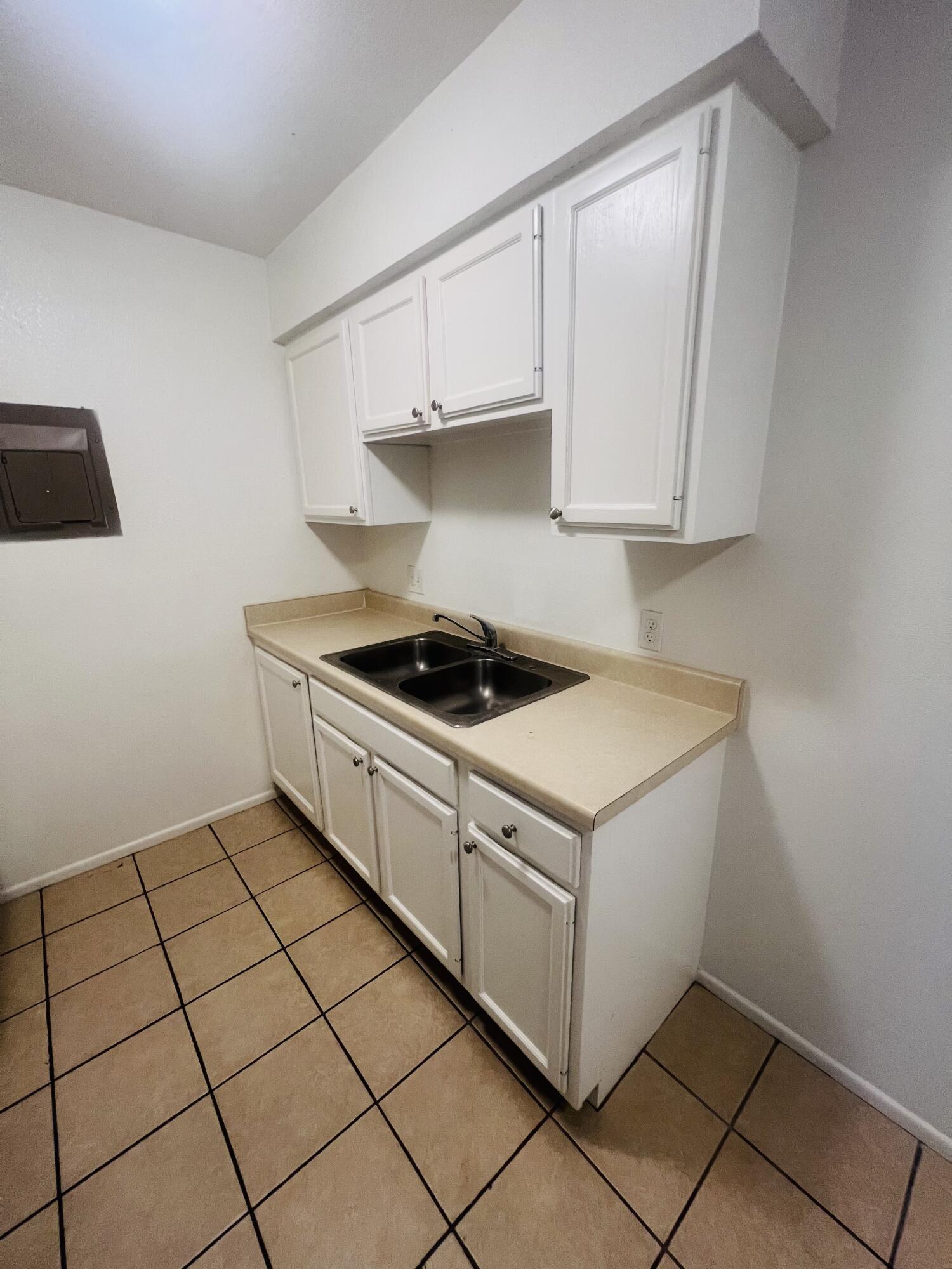 802 Matthew Avenue Sundown, TX 79372 - Photo 16 of 22 a kitchen with a cabinets and a stove top oven
