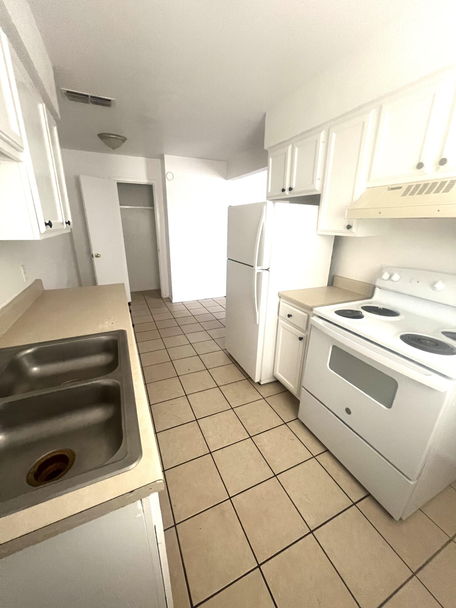 802 Matthew Avenue Sundown, TX 79372 - Photo 2 of 22 a kitchen with a stove cabinets and a window