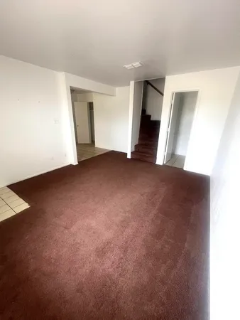 an empty room with a fireplace and cabinet