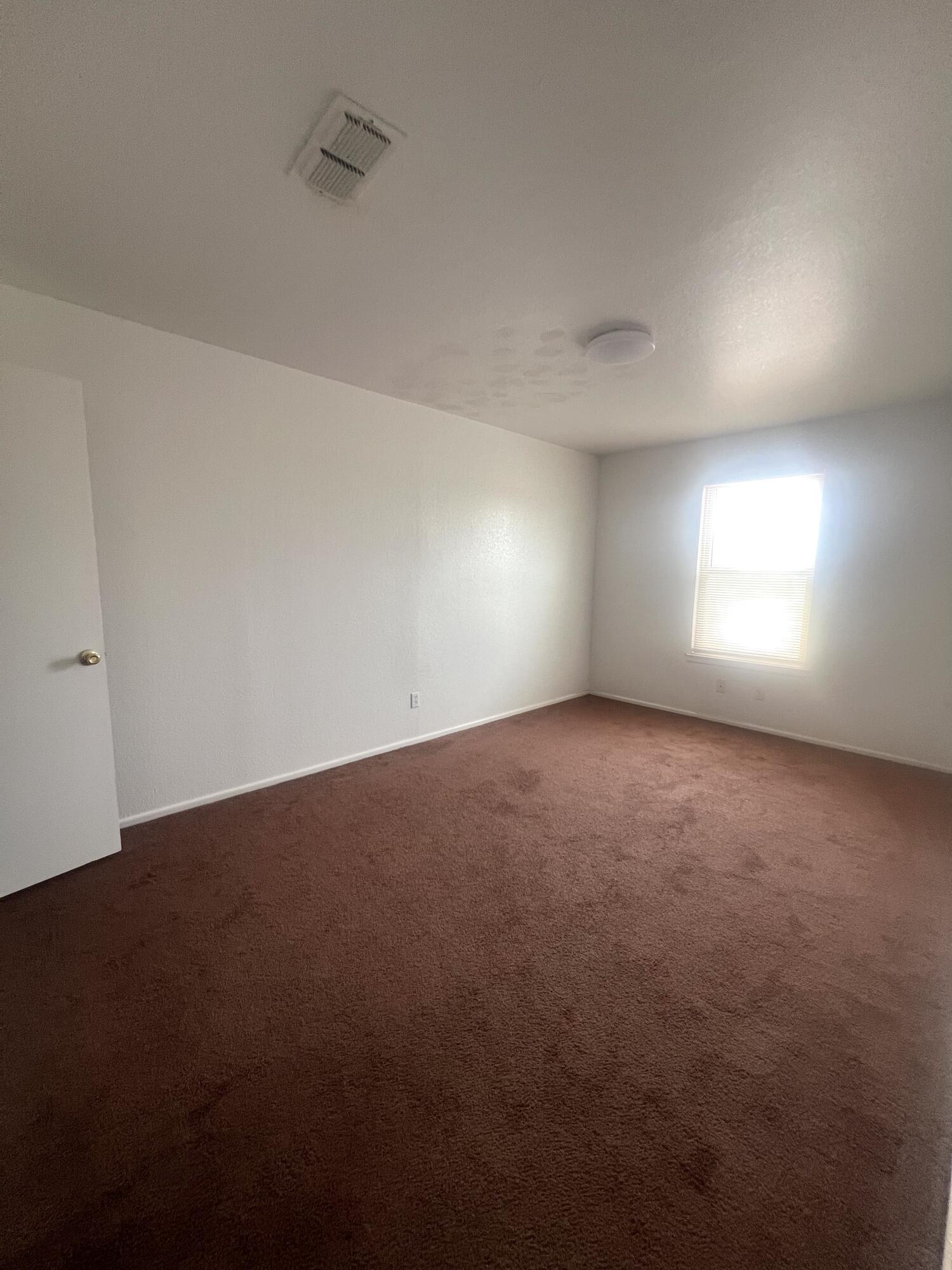 802 Matthew Avenue Sundown, TX 79372 - Photo 10 of 22 an empty room with windows and closet