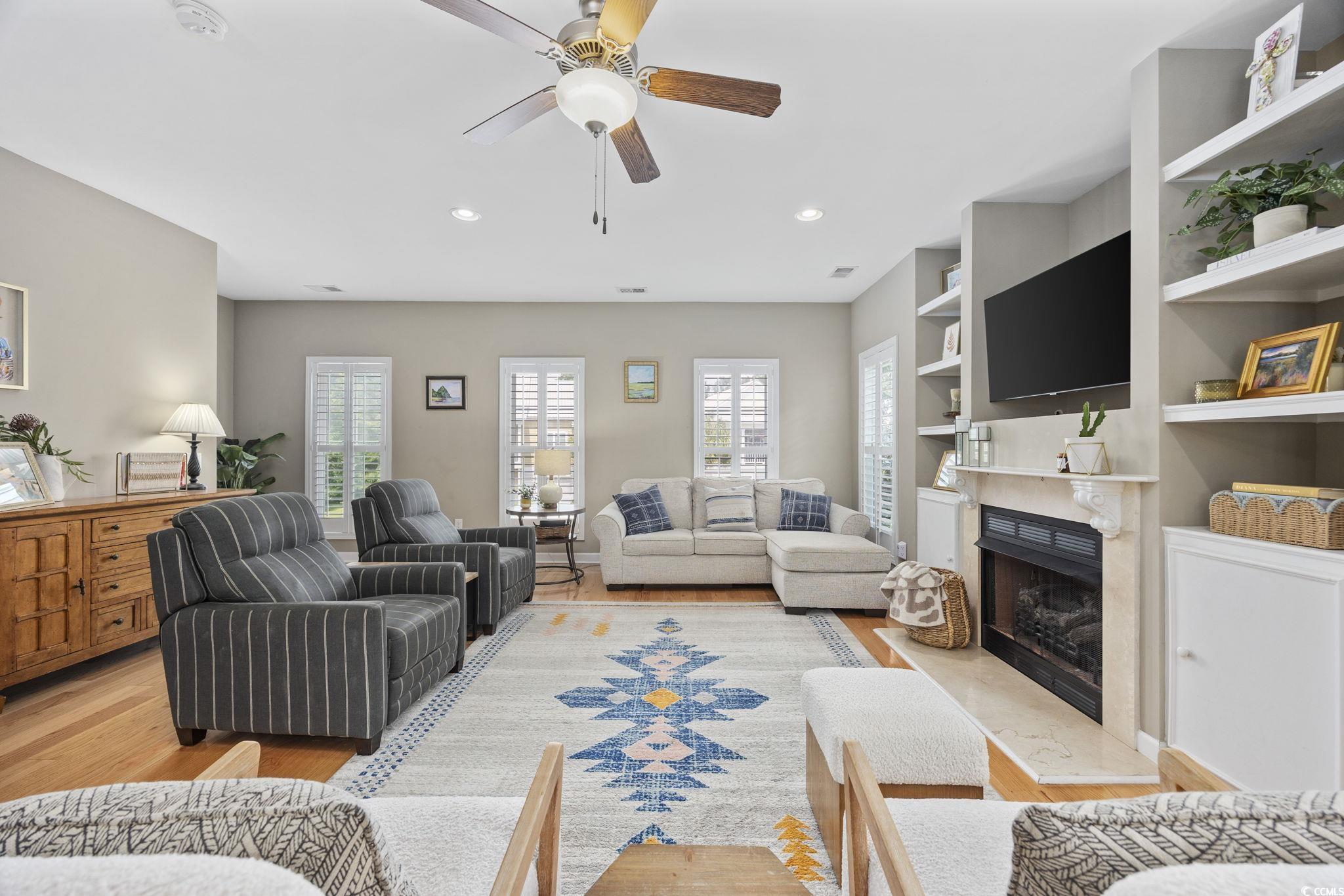 175 SummerWind Loop Murrells Inlet, SC 29576 - Photo 11 of 39 Living area with a fireplace, light wood-type floo