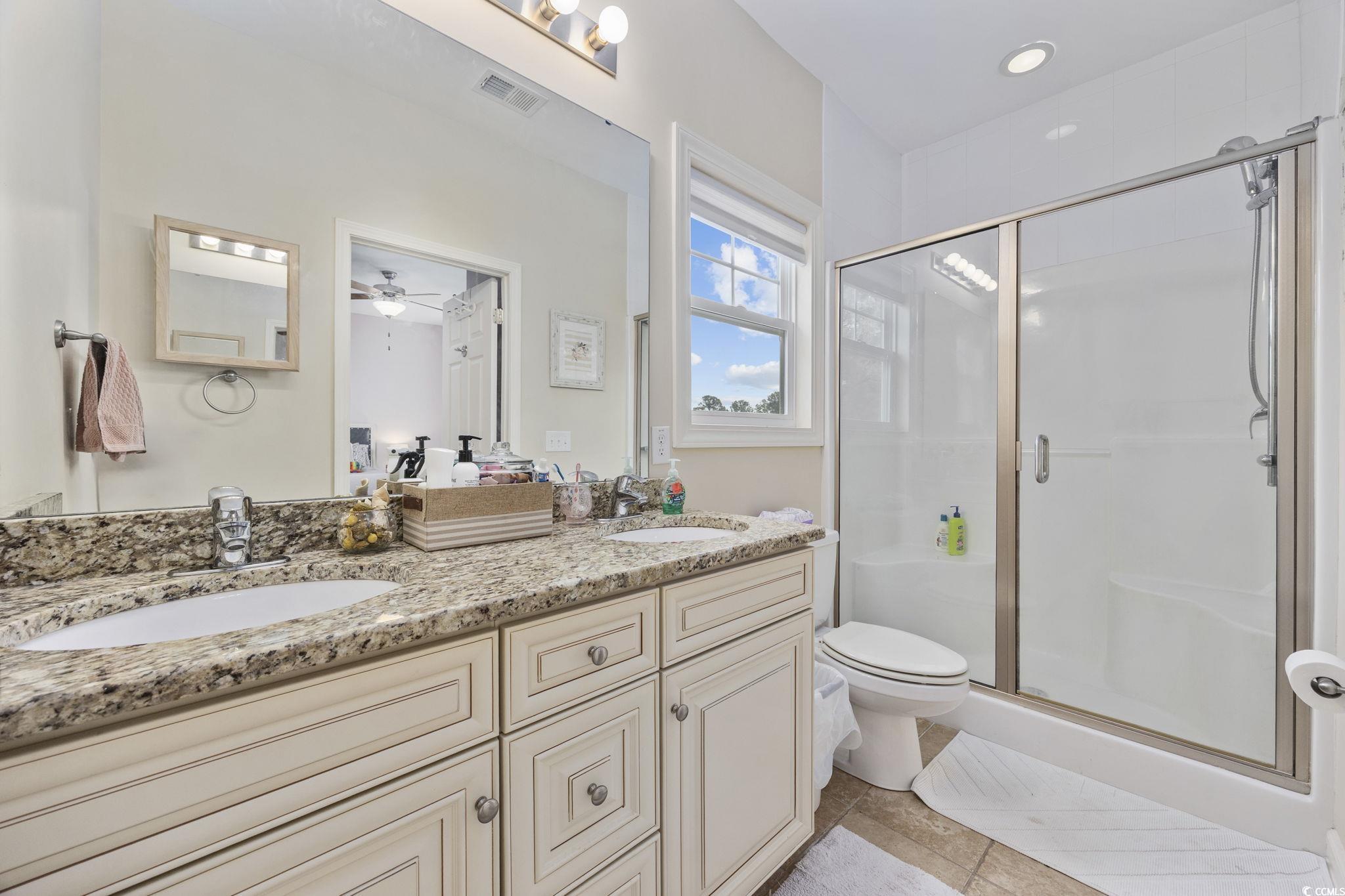 175 SummerWind Loop Murrells Inlet, SC 29576 - Photo 18 of 39 Bathroom with a stall shower, double vanity, toile