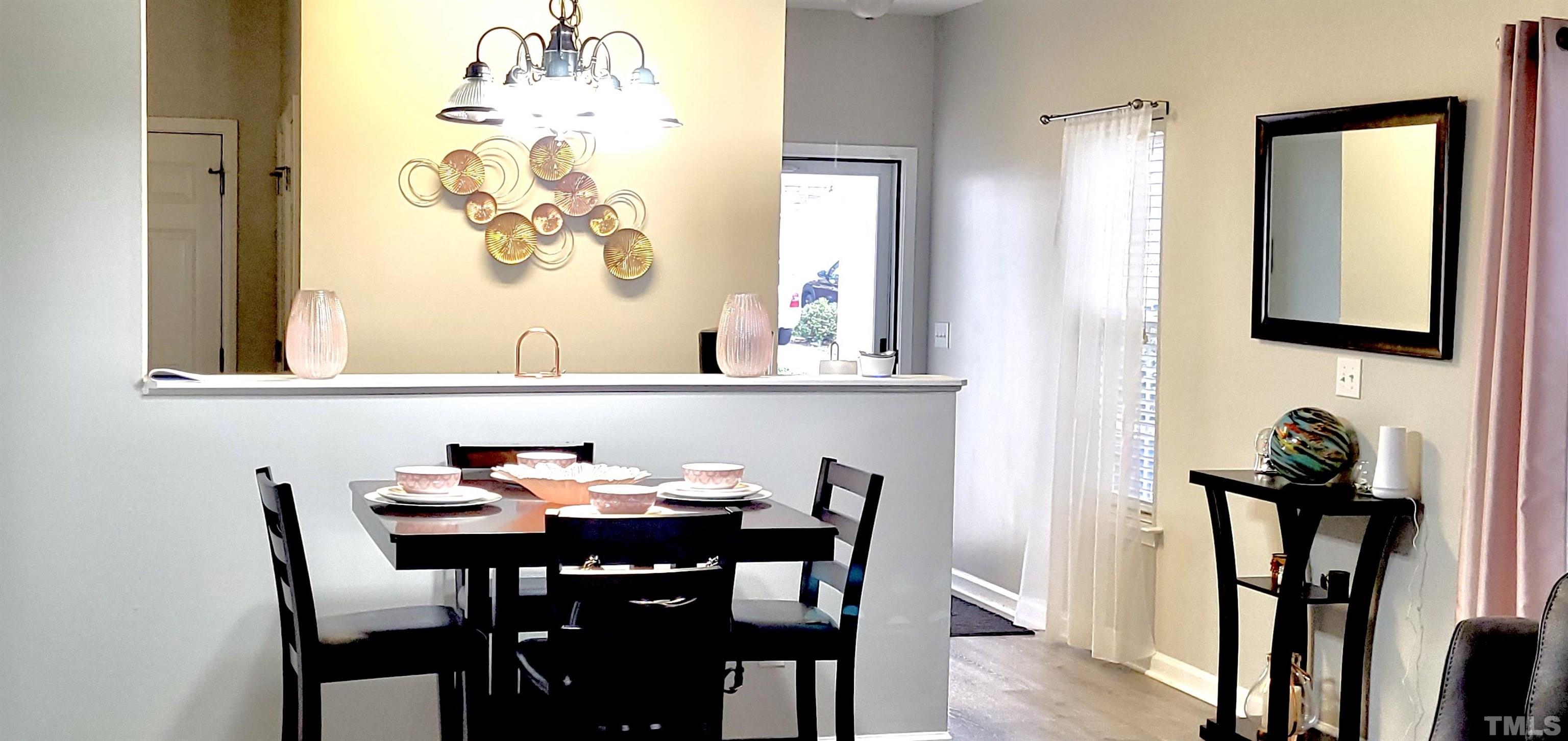 2109 Persimmon Ridge Drive Raleigh, NC 27604 - Photo 4 of 15 a view of a dining room with furniture and wooden floor