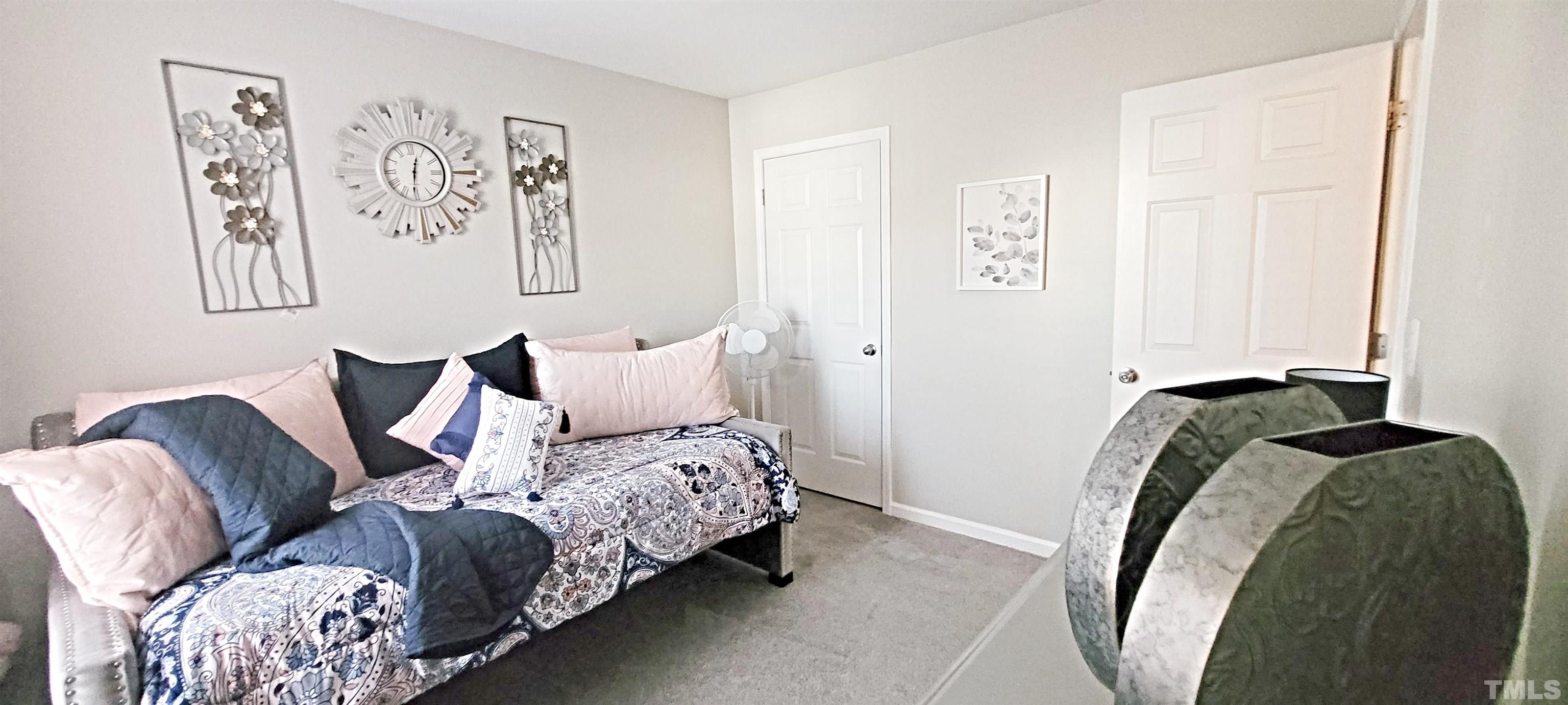 2109 Persimmon Ridge Drive Raleigh, NC 27604 - Photo 9 of 15 a bedroom with a bed and painting on the wall