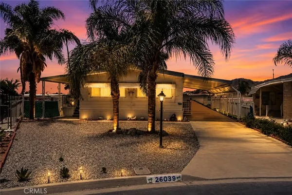 a palm tree sitting in front of a house