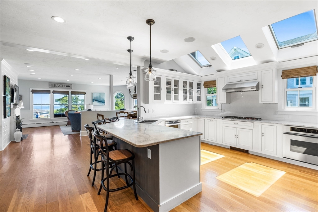 15 Sheldon Road Cohasset, MA 02025 - Photo 20 of 41 a kitchen with stainless steel appliances granite countertop a kitchen island a stove a table and chairs in it