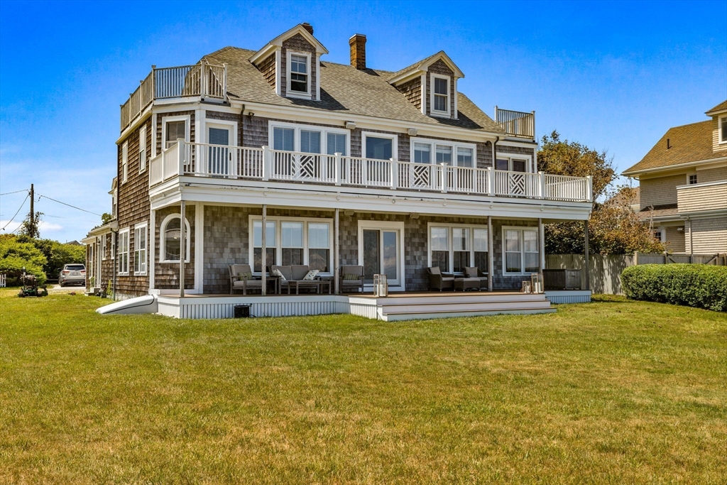 15 Sheldon Road Cohasset, MA 02025 - Photo 38 of 41 a front view of a building with swimming pool having outdoor seating