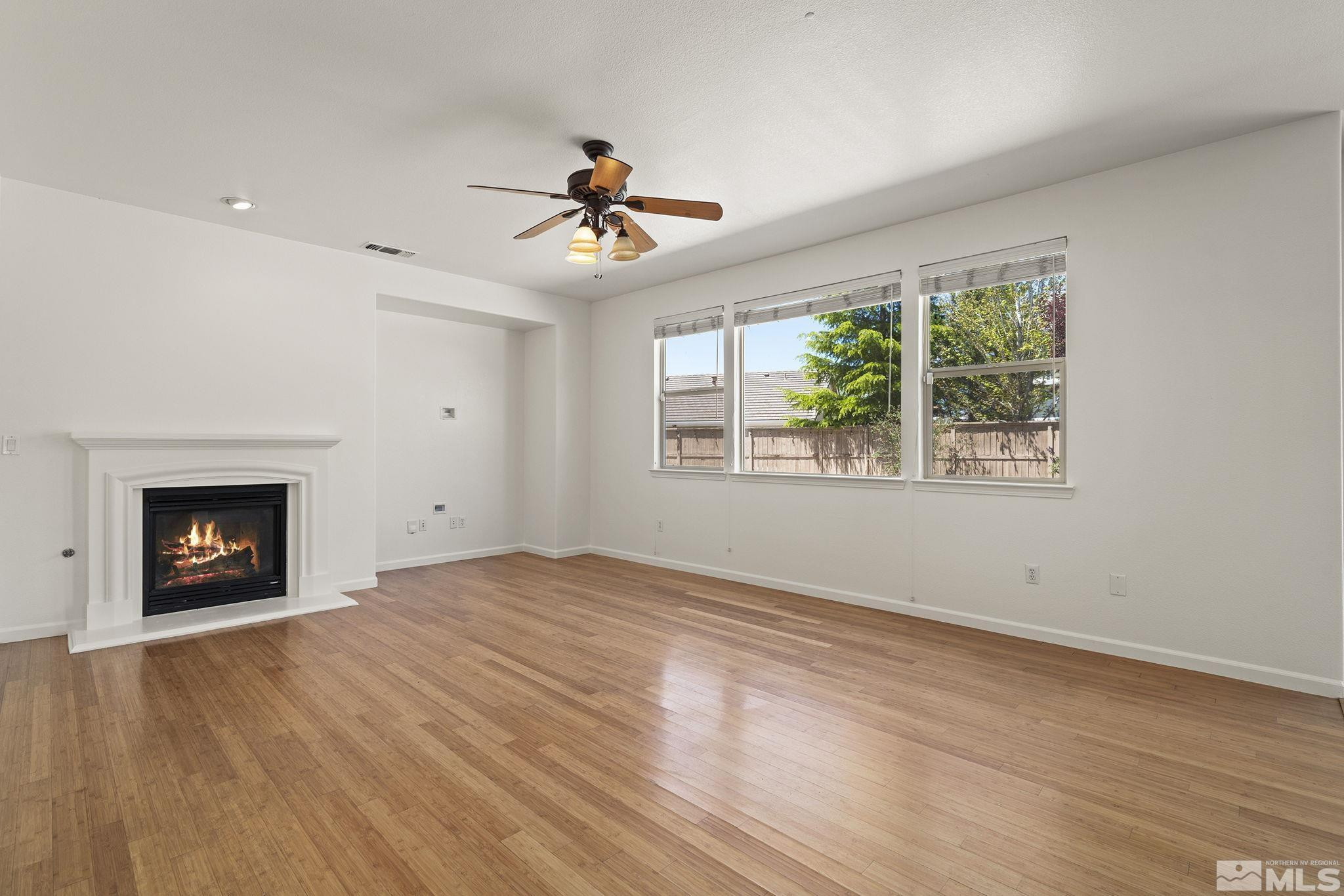 10655 Birch Point Court Reno, NV 89521 - Photo 3 of 19 a view of an empty room with a fireplace and a window