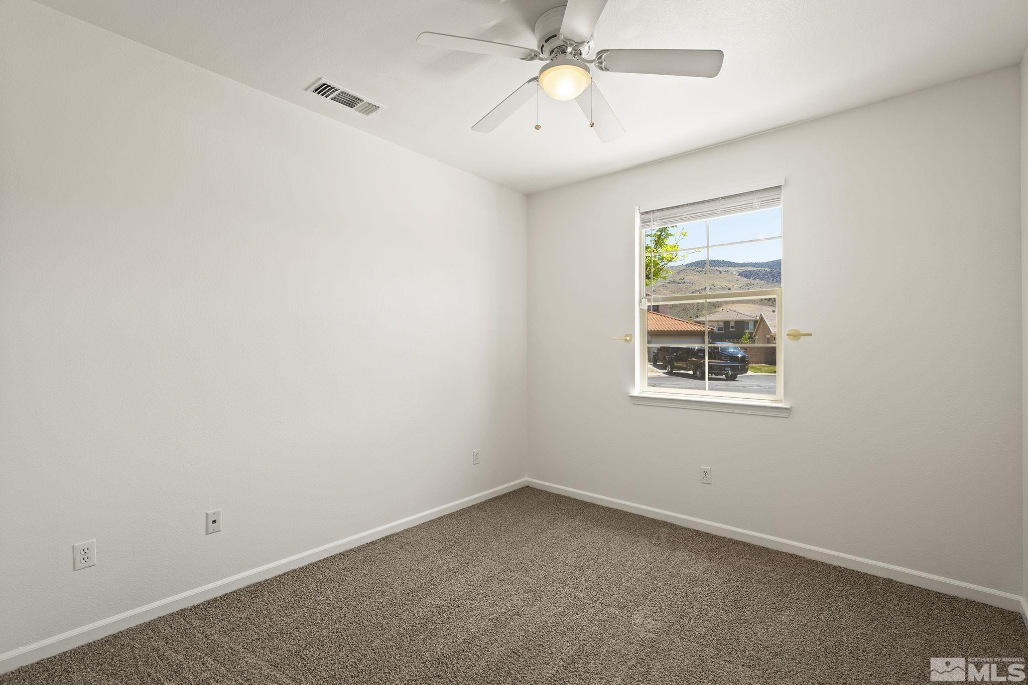 10655 Birch Point Court Reno, NV 89521 - Photo 10 of 19 an empty room with a window and a fan