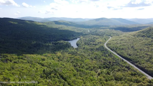 an aerial view of residential house with space and trees all around