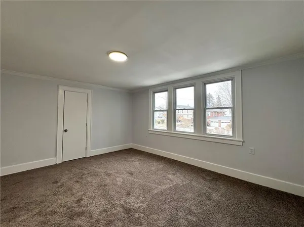 an empty room with windows and closet