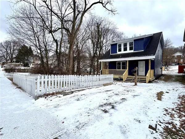 a view of a house with a yard covered in snow