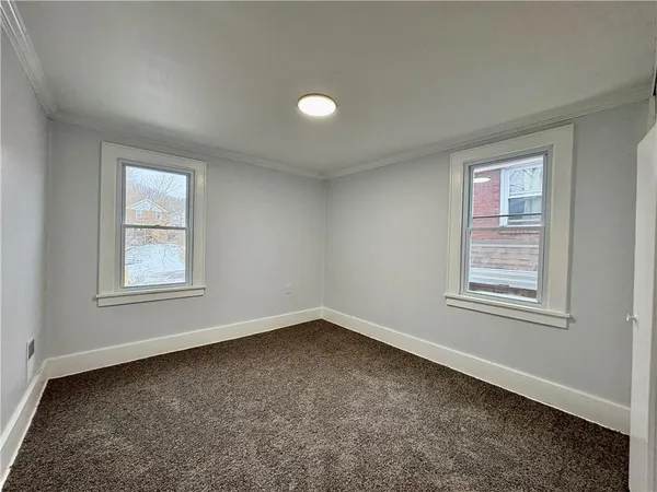 an empty room with windows and closet