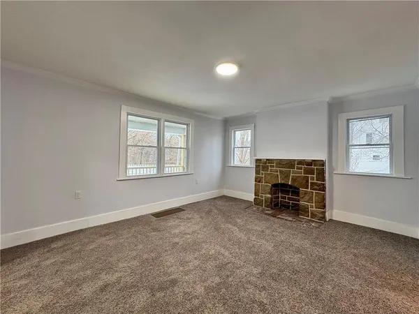 an empty room with furniture and a fireplace