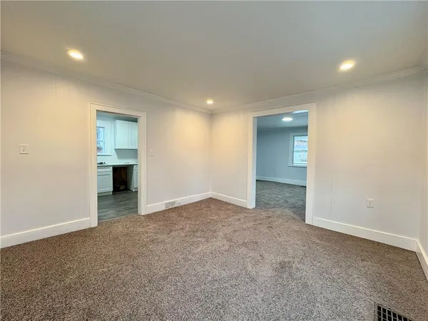 an empty room with a bathroom and a sink