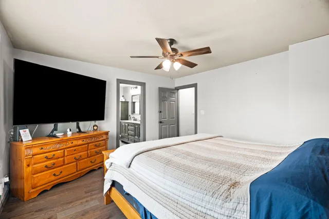 a very nice looking kitchen with a large window wooden floor and stainless steel appliances