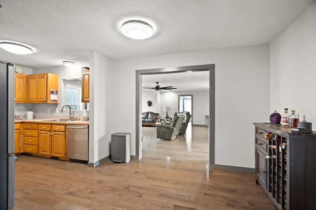 a kitchen with stainless steel appliances granite countertop a sink and a refrigerator