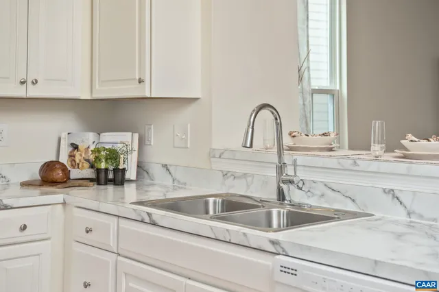 a kitchen with sink and cabinets