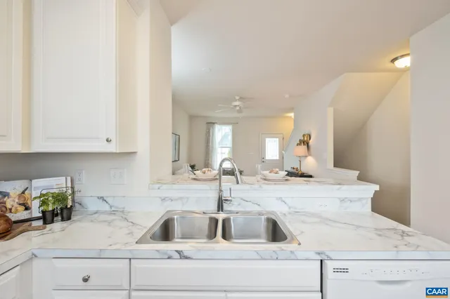 a kitchen with sink and cabinets