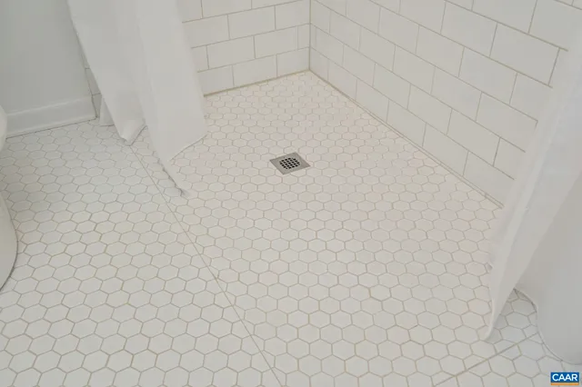 a bathroom with a white wall