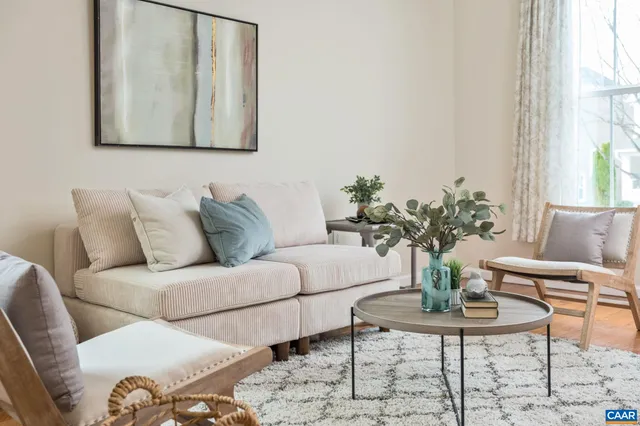 a living room with furniture and a potted plant