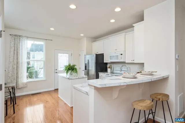 a kitchen with a sink a stove a refrigerator and cabinets